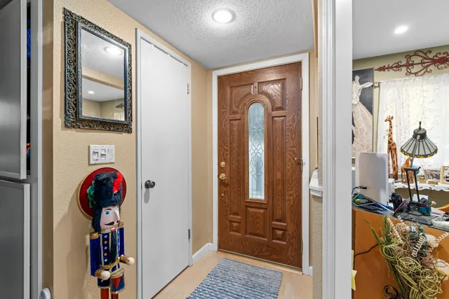a view of hallway with wooden floor and stairs