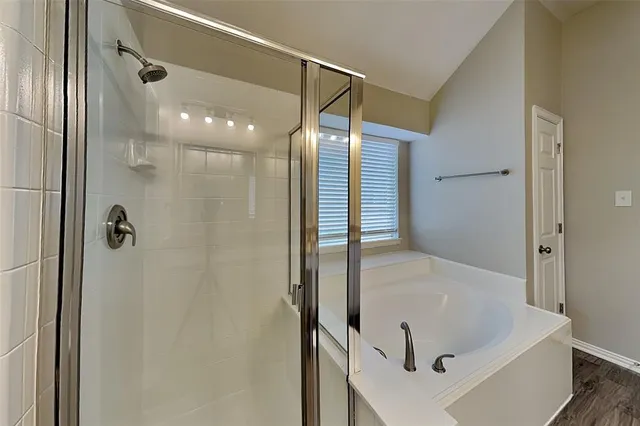 a bathroom with a bathtub and shower