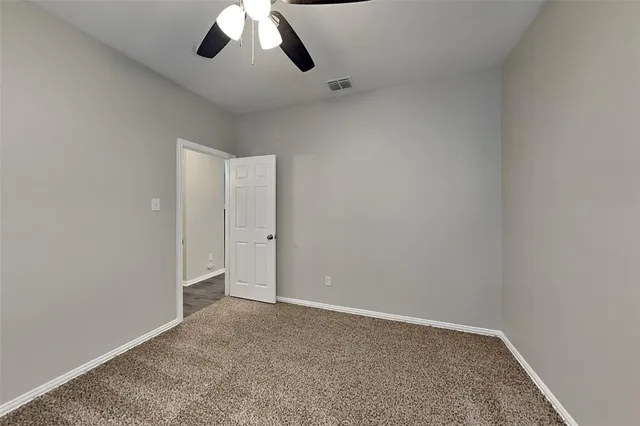 an empty room with a empty space and chandelier fan