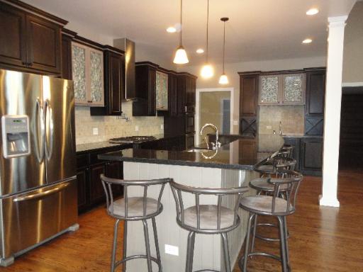 32W630 Army Trail Road Wayne, IL 60184 - Photo 5 of 16 a kitchen with stainless steel appliances a dining table chairs and refrigerator