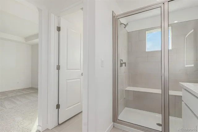 a bathroom with a glass shower door