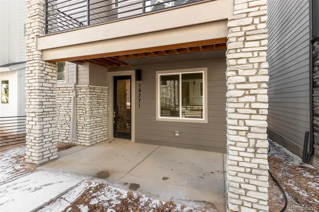 a view of a brick house with large windows