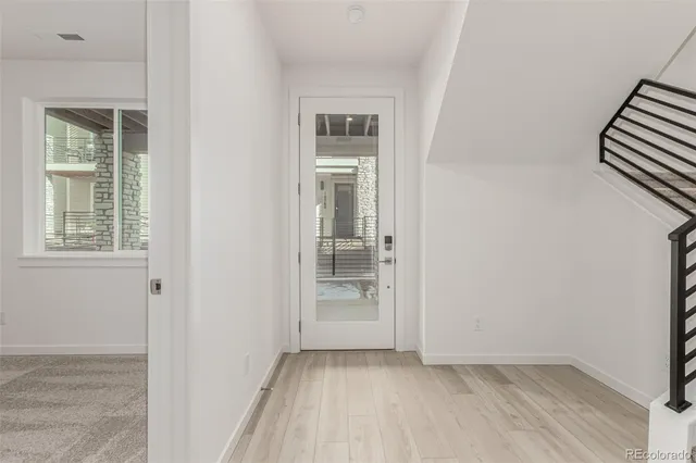 a view of an empty room with closet and a window