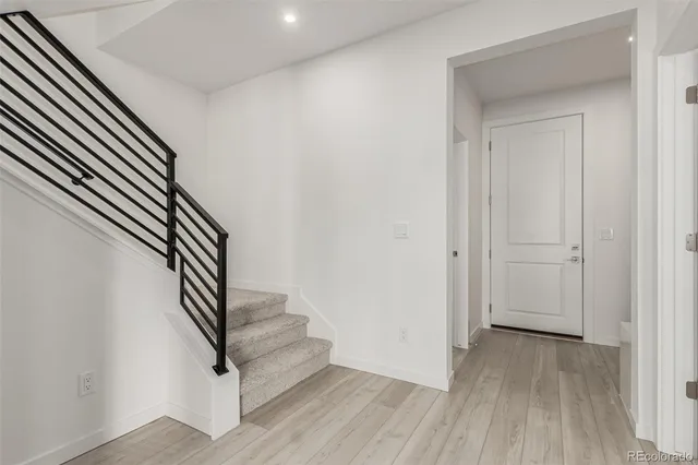 an entryway in a hallway with wooden floor
