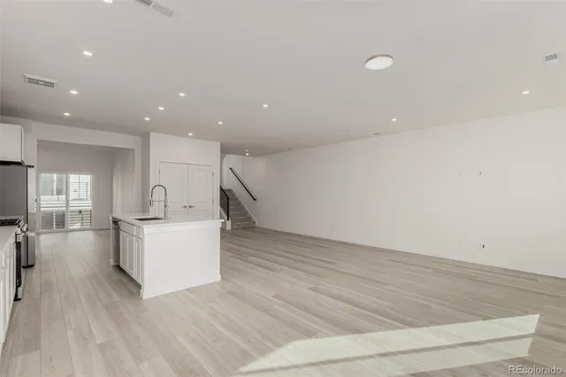 a view of kitchen with furniture and wooden floor