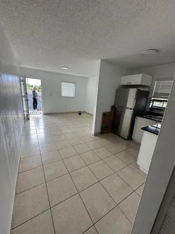 a view of an empty room and a hallway
