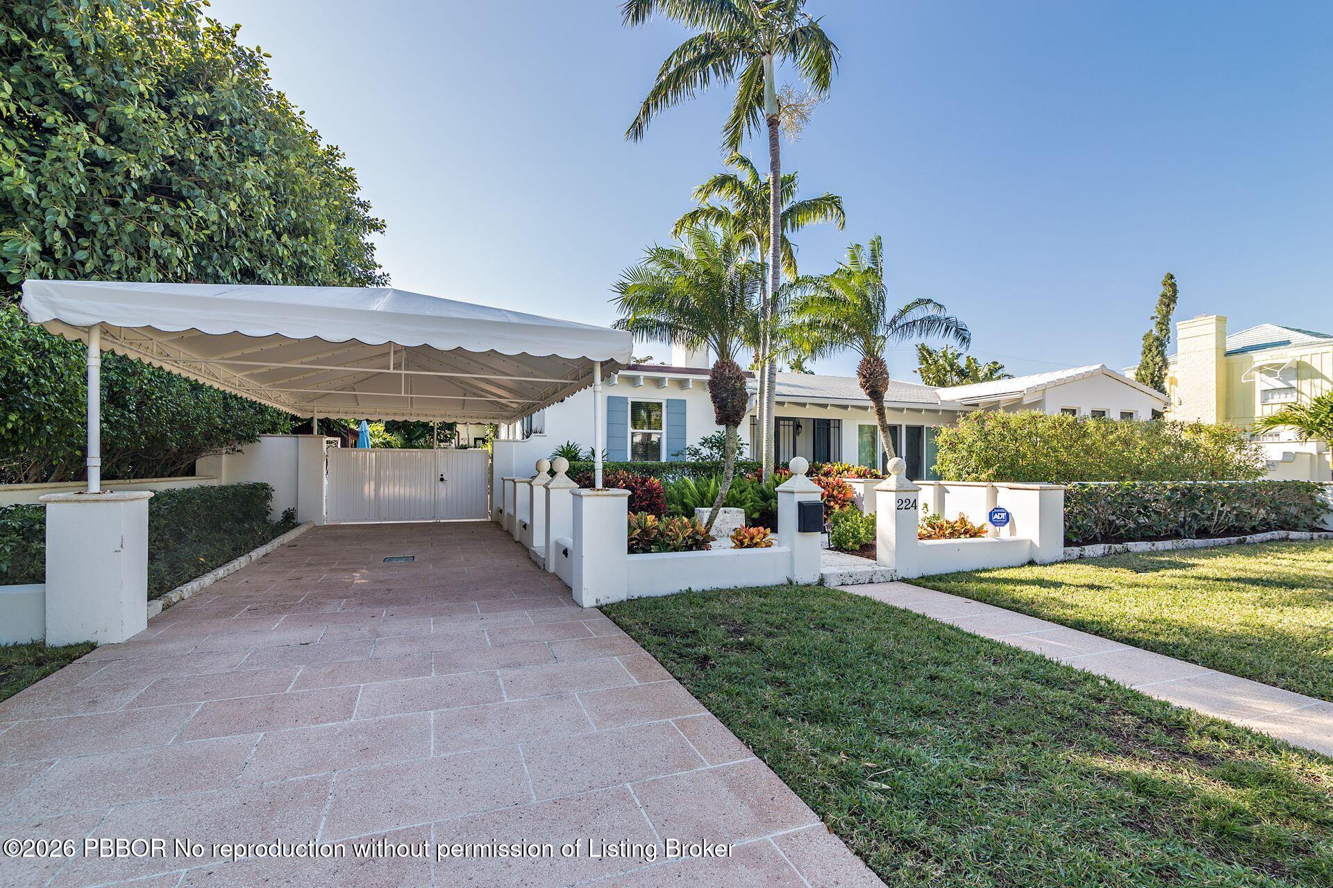 224 Churchill Road West Palm Beach, FL 33405 - Photo 2 of 33 a view of a house with swimming pool and a yard