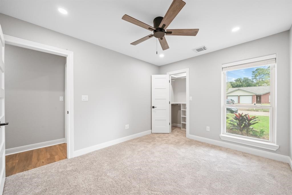 23307 Apple Arbor Drive Spring, TX 77373 - Photo 12 of 32 a view of a livingroom with a ceiling fan & a window