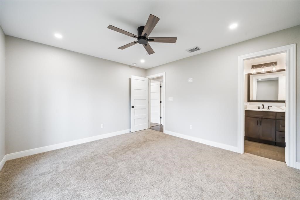 23307 Apple Arbor Drive Spring, TX 77373 - Photo 16 of 32 a view of a livingroom with a ceiling fan & kitchen space