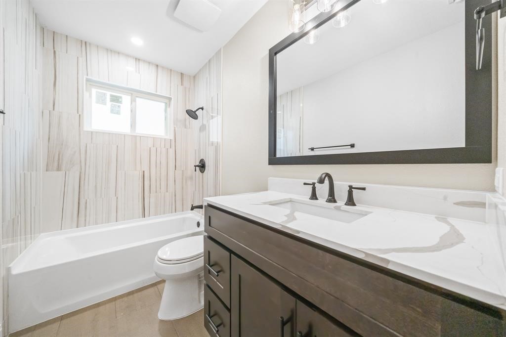 23307 Apple Arbor Drive Spring, TX 77373 - Photo 21 of 32 a bathroom with a granite countertop sink toilet a large mirror and shower