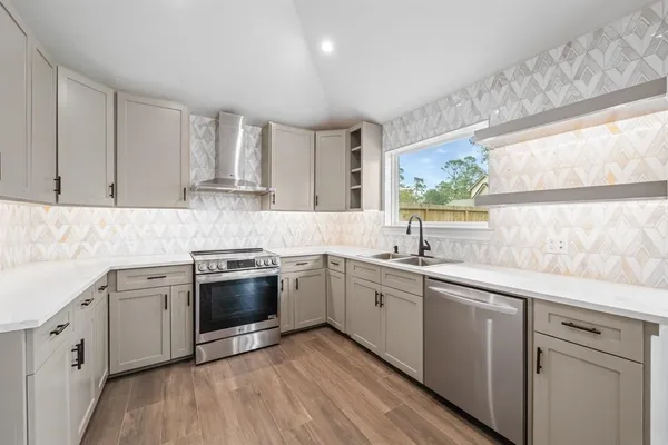 a kitchen with a sink stove and cabinets