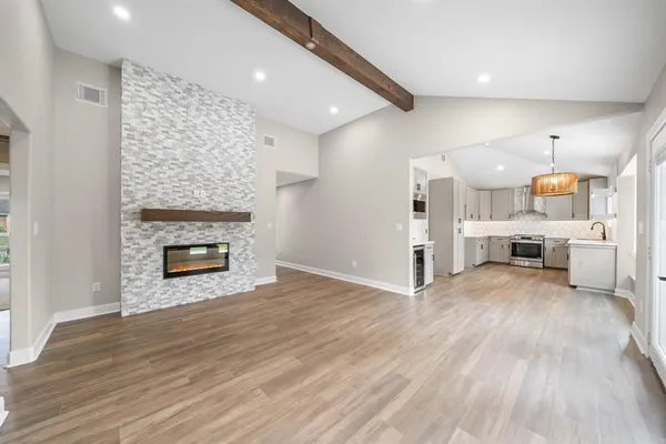 a view of a kitchen with a sink and a fireplace