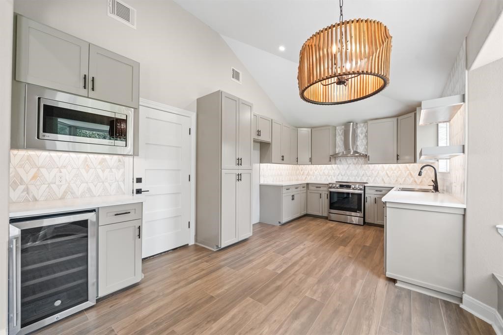 23307 Apple Arbor Drive Spring, TX 77373 - Photo 32 of 32 a kitchen with stainless steel appliances a stove a sink and a microwave