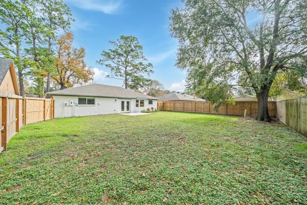23307 Apple Arbor Drive Spring, TX 77373 - Photo 5 of 32 a front view of a house with a yard and trees