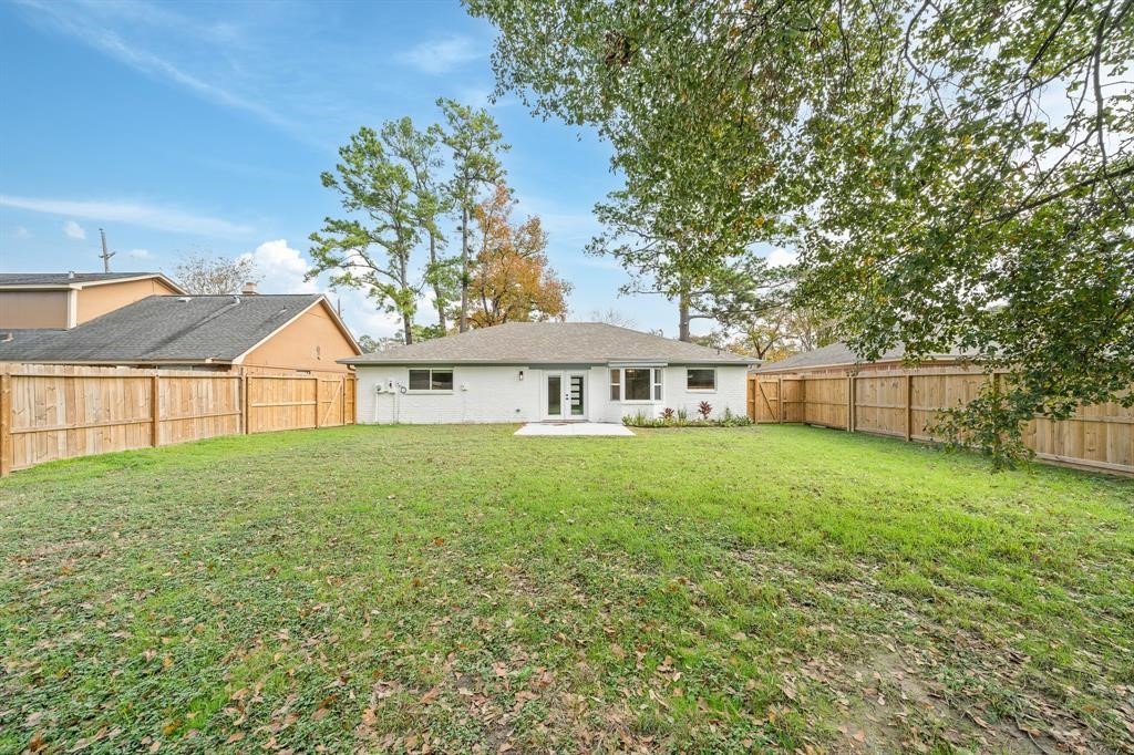 23307 Apple Arbor Drive Spring, TX 77373 - Photo 6 of 32 a view of a yard in front of a house with large trees