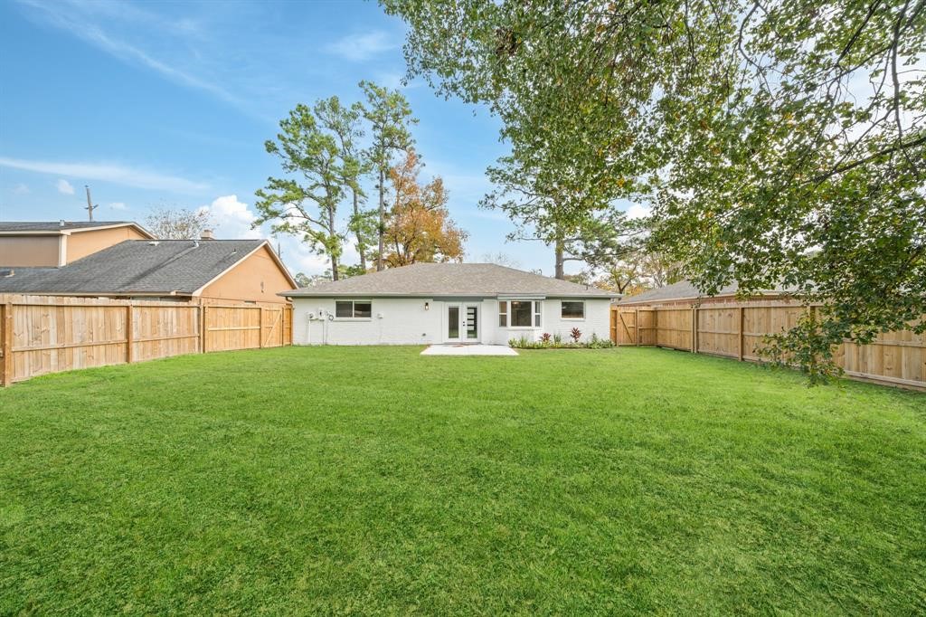 23307 Apple Arbor Drive Spring, TX 77373 - Photo 7 of 32 a view of a house next to a big yard and large trees