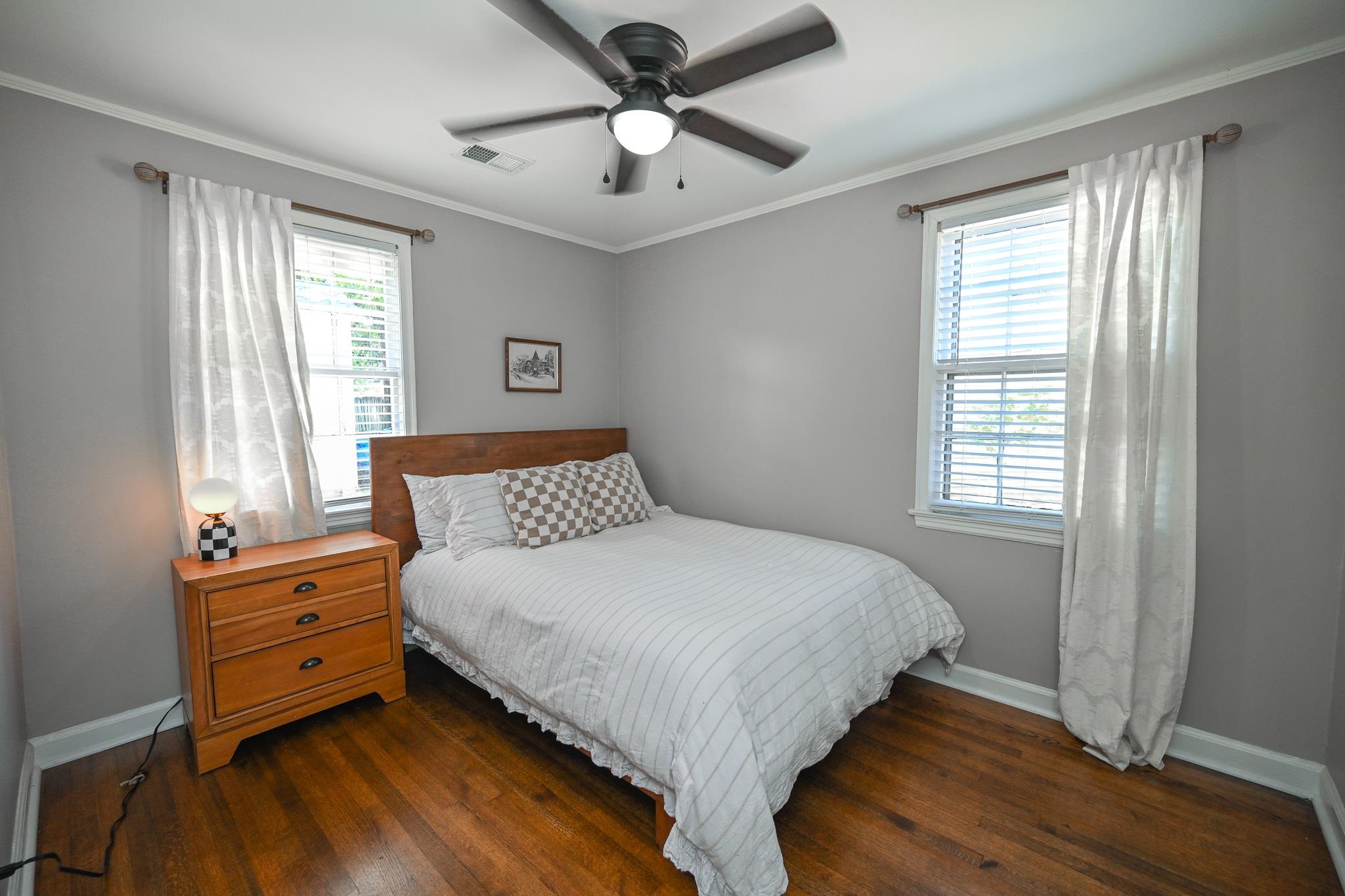 1105 Stratford Road Memphis, TN 38122 - Photo 14 of 26 Bedroom with crown molding, dark wood-style flooring, and ceiling fan