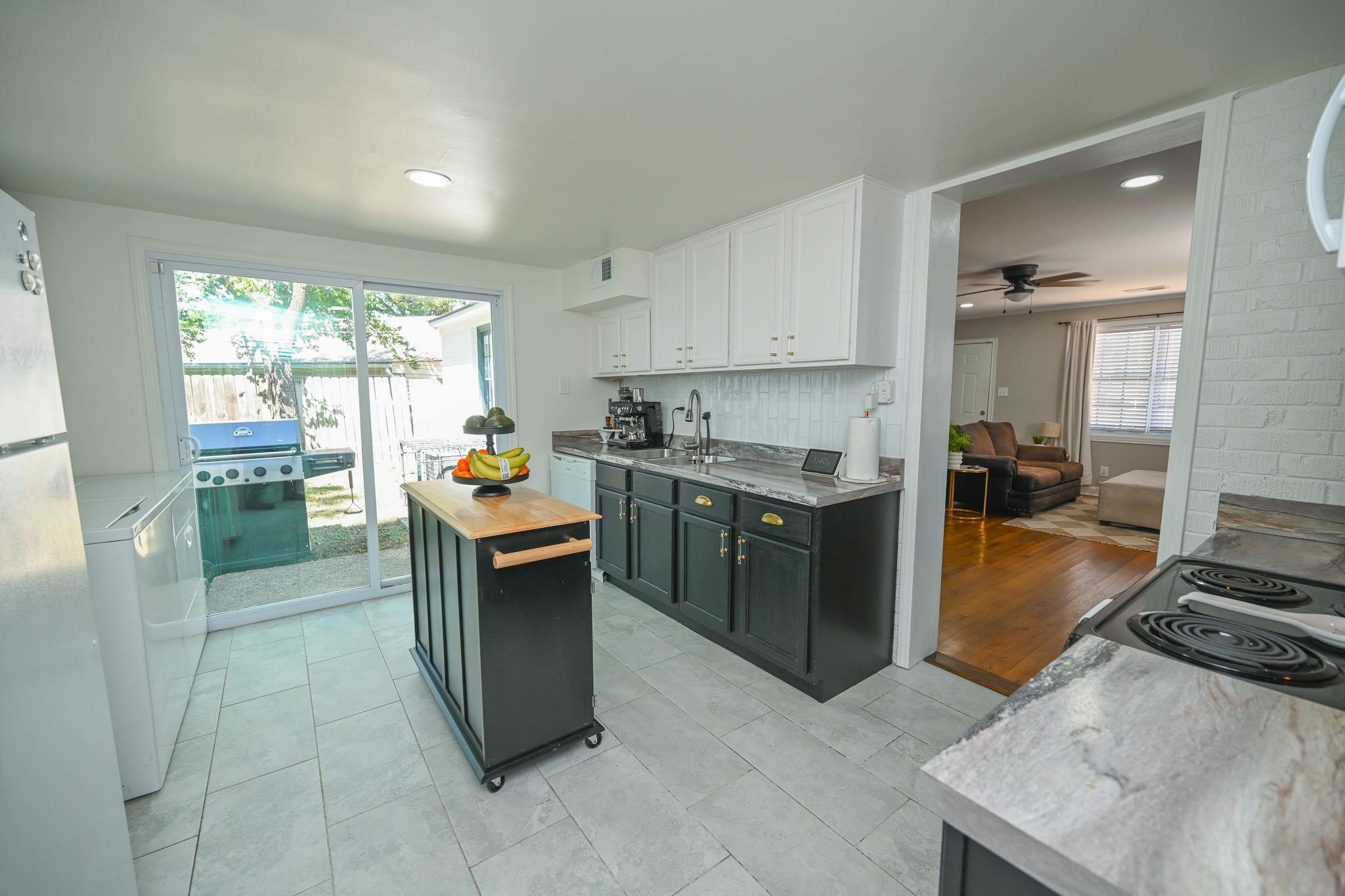 1105 Stratford Road Memphis, TN 38122 - Photo 18 of 26 Kitchen with butcher block countertops, freestanding refrigerator, white cabinets, backsplash, and washer / clothes dryer