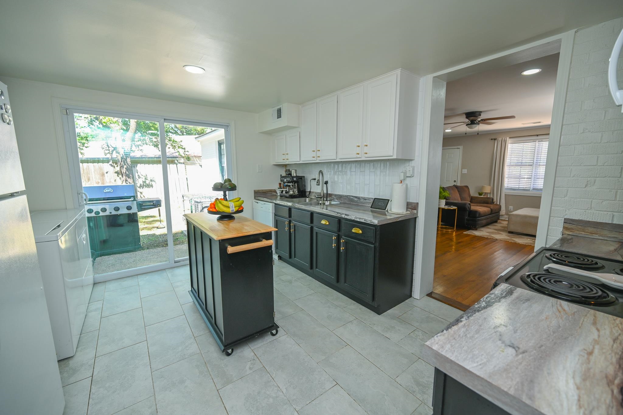 1105 Stratford Road Memphis, TN 38122 - Photo 19 of 26 Kitchen with backsplash, white cabinetry, butcher block counters, freestanding refrigerator, and a ceiling fan