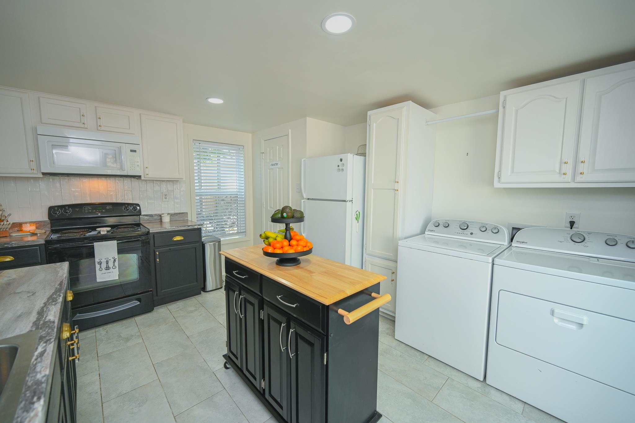 1105 Stratford Road Memphis, TN 38122 - Photo 20 of 26 Kitchen with white appliances, dark cabinets, backsplash, white cabinetry, and recessed lighting