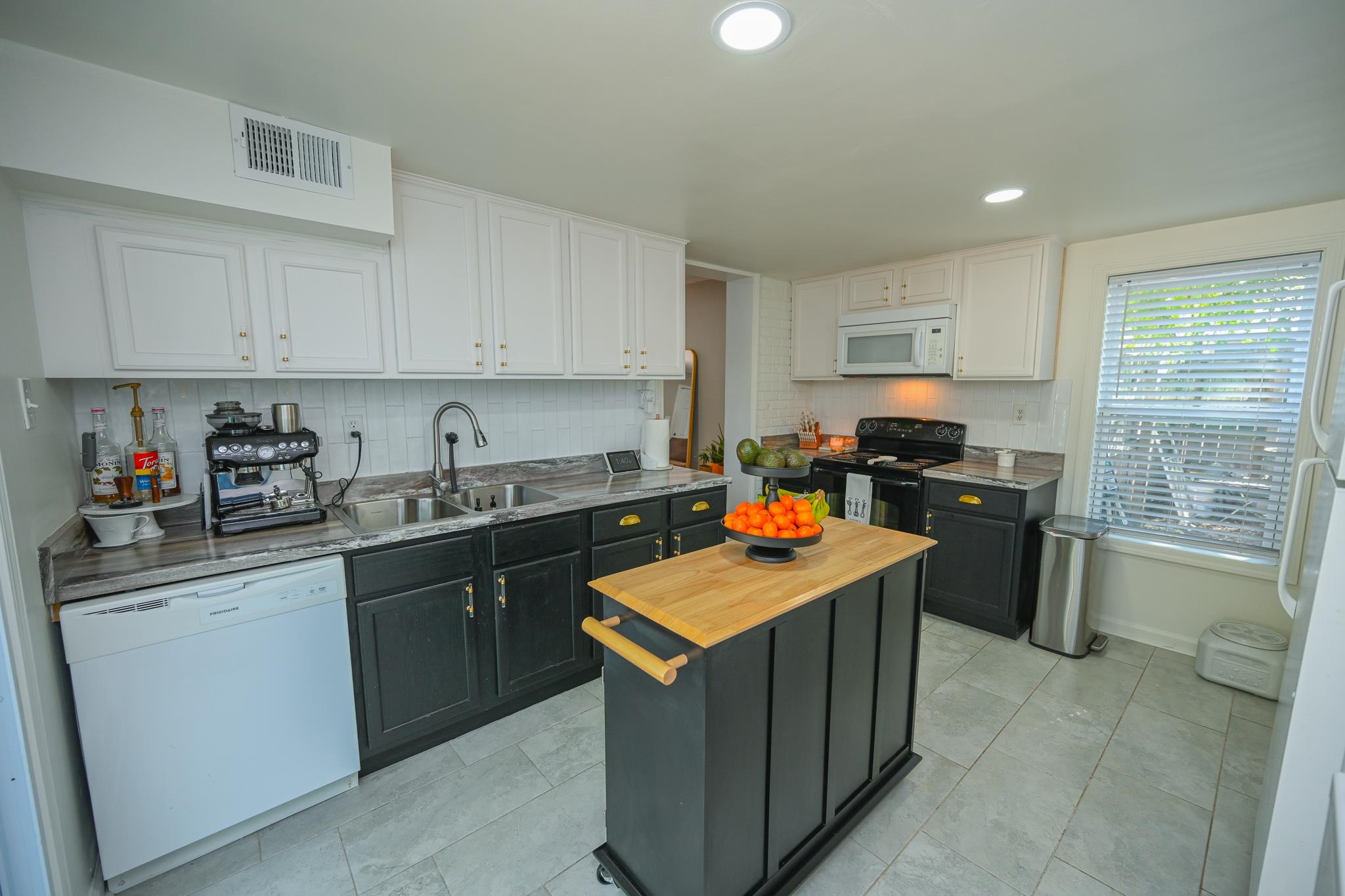 1105 Stratford Road Memphis, TN 38122 - Photo 21 of 26 Kitchen featuring backsplash, white cabinetry, white appliances, recessed lighting, and light tile patterned floors
