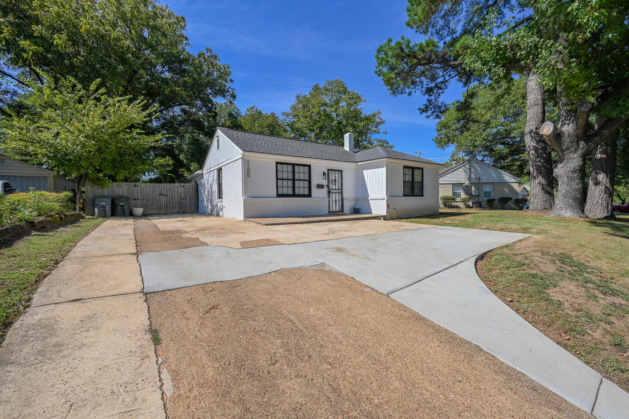 1105 Stratford Road Memphis, TN 38122 - Photo 3 of 26 View of front of house featuring brick siding, driveway, a shingled roof, and a chimney