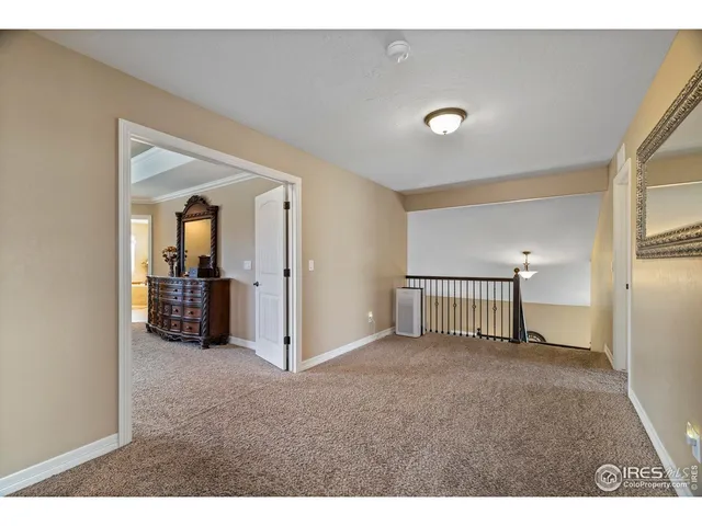 a view of a hallway with a livingroom and a bathroom