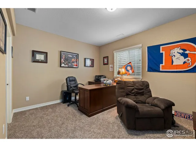 a living room with furniture and wall paintings