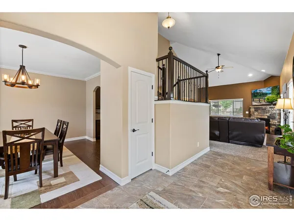 a living room with furniture and a dining table with kitchen view