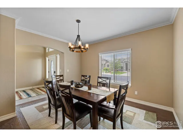 a view of a dining room with furniture and chandelier