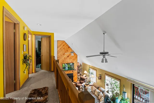 a view of a livingroom with furniture and staircase