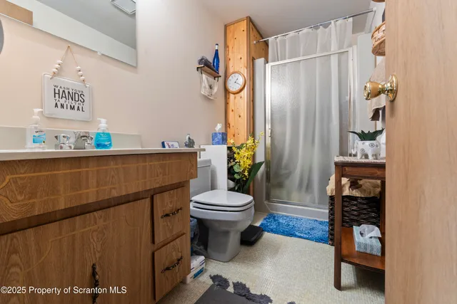 a bathroom with a toilet and a shower