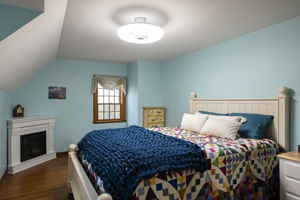 16 Granite Street Wellesley, MA 02482 - Photo 11 of 14 a bedroom with a bed and a fireplace