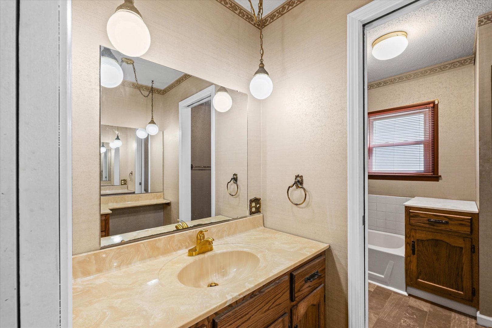 309 North Watson Street Tolono, IL 61880 - Photo 18 of 33 a bathroom with a sink a mirror and a shower