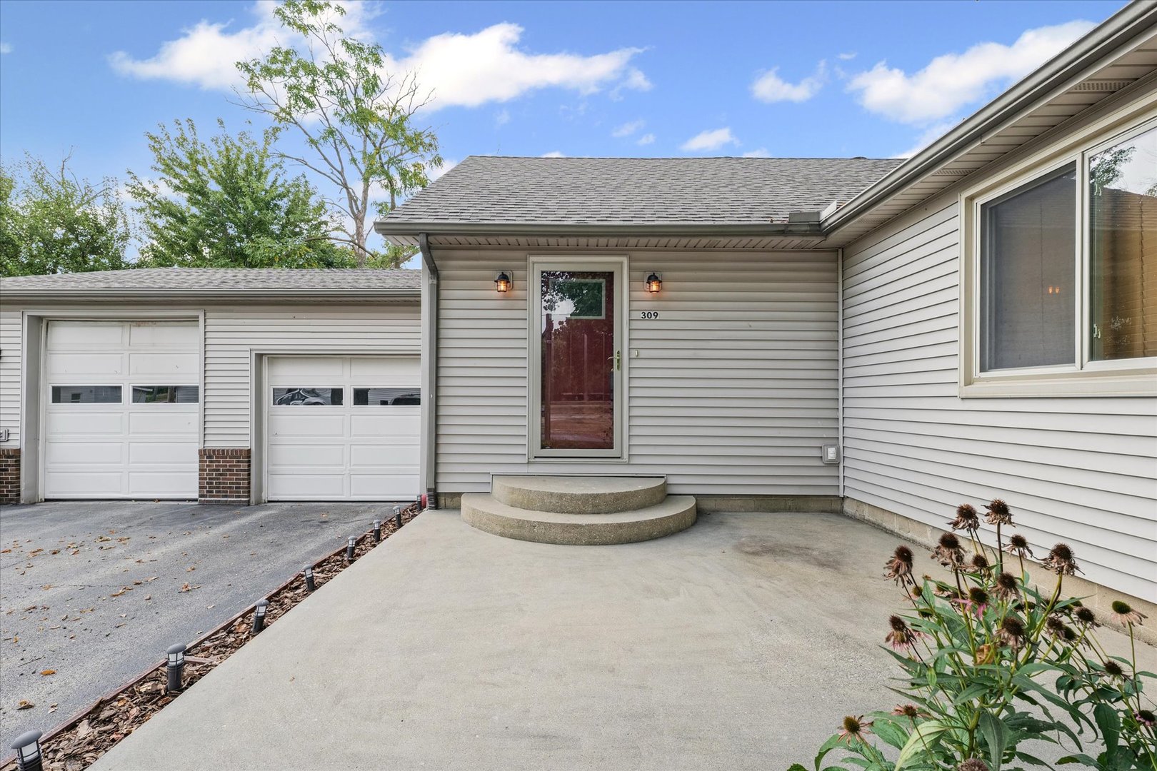 309 North Watson Street Tolono, IL 61880 - Photo 3 of 33 a front view of a house with a garage