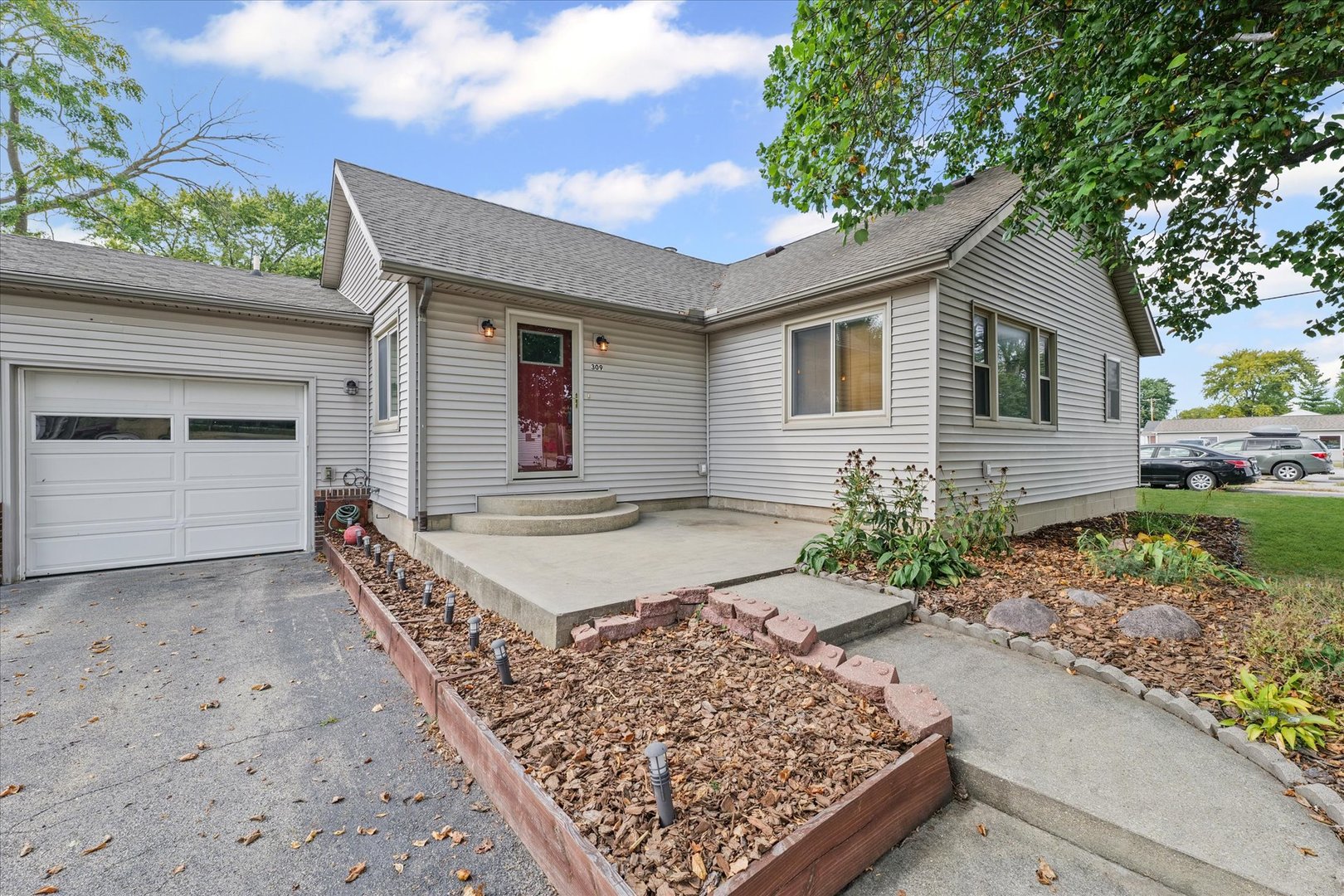 309 North Watson Street Tolono, IL 61880 - Photo 4 of 33 a front view of a house with garden