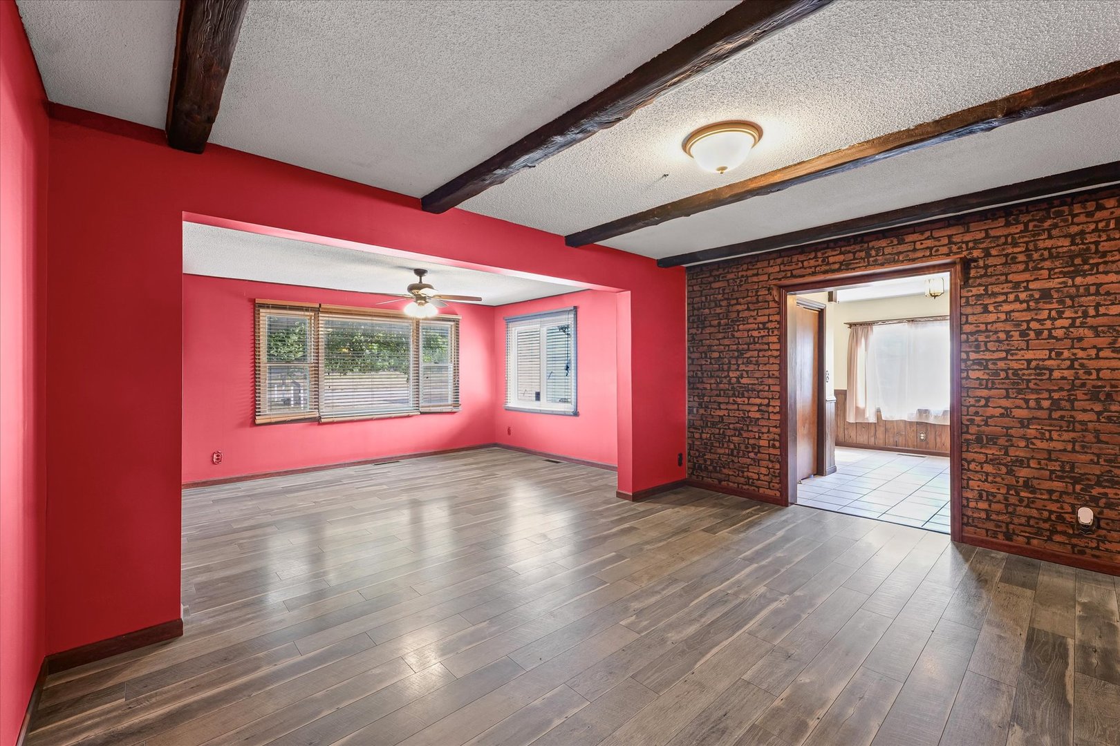 309 North Watson Street Tolono, IL 61880 - Photo 7 of 33 a view of an empty room with window and wooden floor