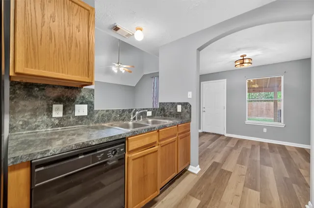 a kitchen with a sink stove and cabinets