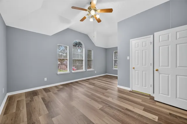 wooden floor in an empty room with a window