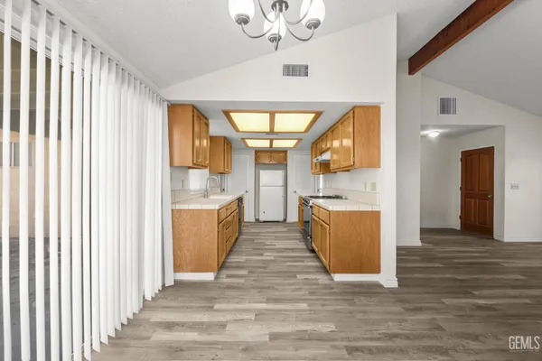 a view of kitchen with sink and wooden floor