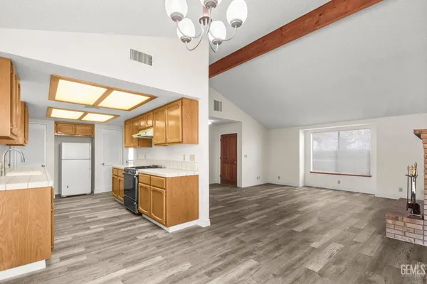 a view of a kitchen with a stove cabinets and wooden floor