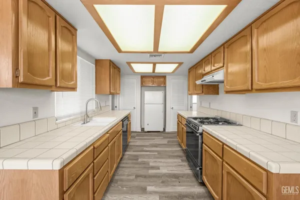 a kitchen with a sink stove and cabinets