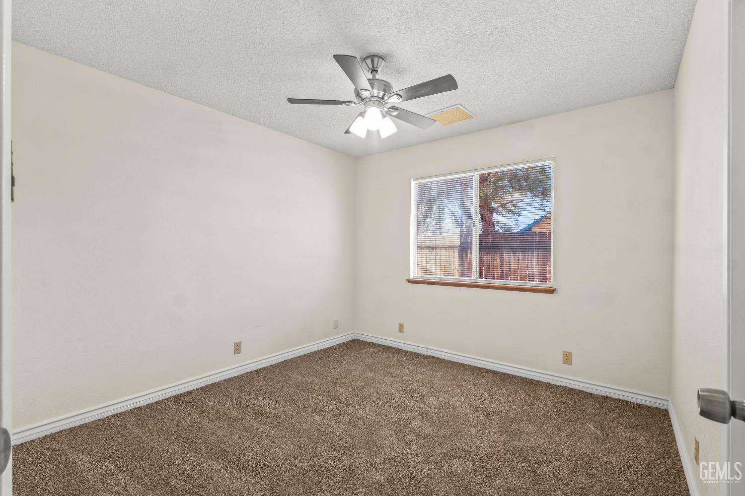 Undisclosed Address Ridgecrest, CA 93555 - Photo 17 of 28 an empty room with a window and a fan