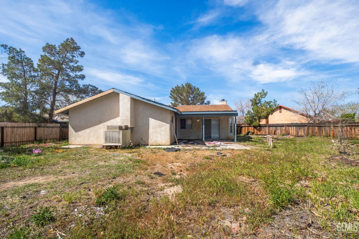 Undisclosed Address Ridgecrest, CA 93555 - Photo 21 of 28 a yellow house with trees in front of it