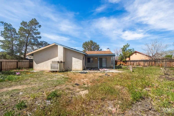 a yellow house with trees in front of it