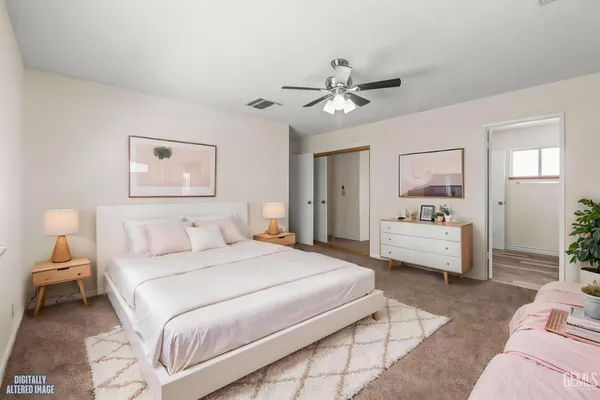 a bedroom with a bed couch and window