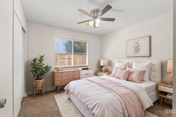 a bedroom with a large bed and a chandelier