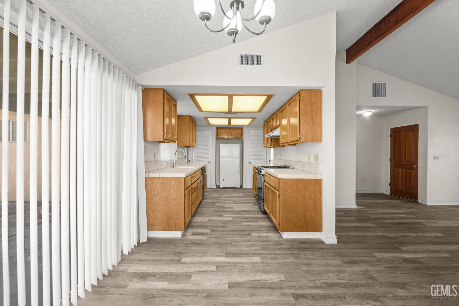 Undisclosed Address Ridgecrest, CA 93555 - Photo 9 of 28 a view of kitchen with sink and wooden floor