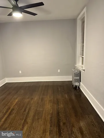 an empty room with wooden floor and closet