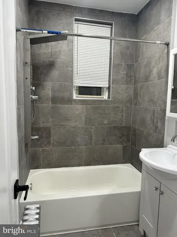 a bathroom with a sink a toilet and bathtub